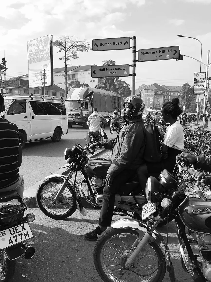 Boda-boda riders waiting at a traffic junction in central Kampala, Uganda.